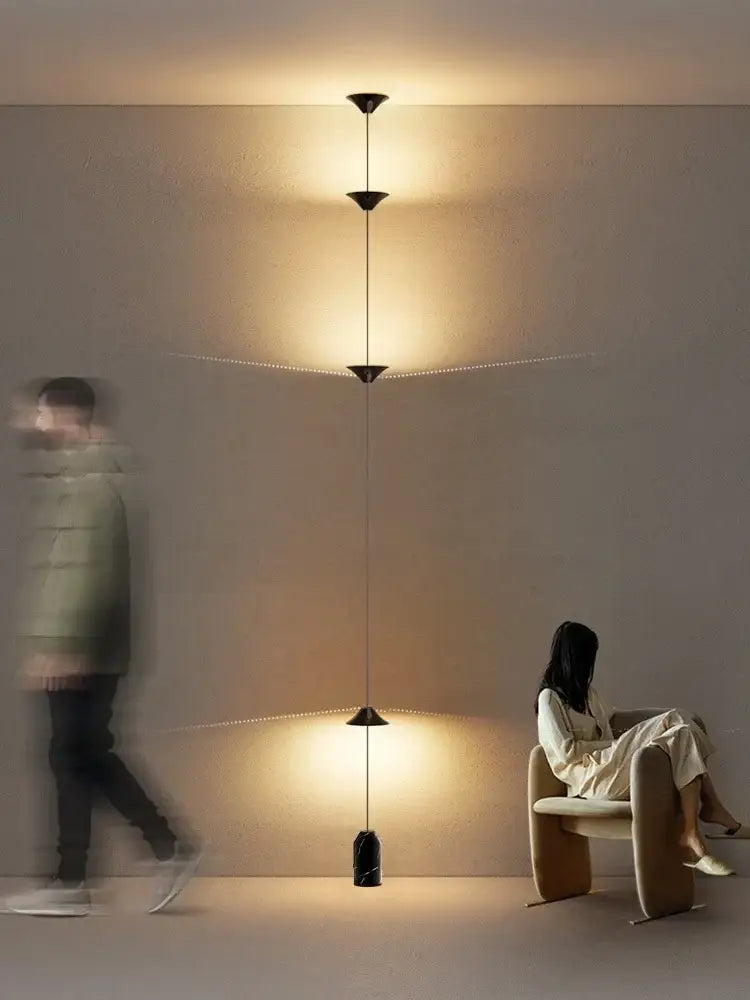 A minimalist black decorbites cone design floor lamp with three conical shades suspended by cords for living room lighting