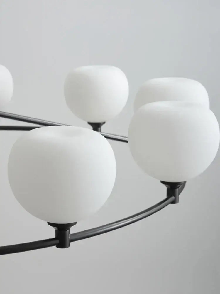 Minimalist black decorbites copper glass chandelier with frosted white spherical shades for dining room lighting