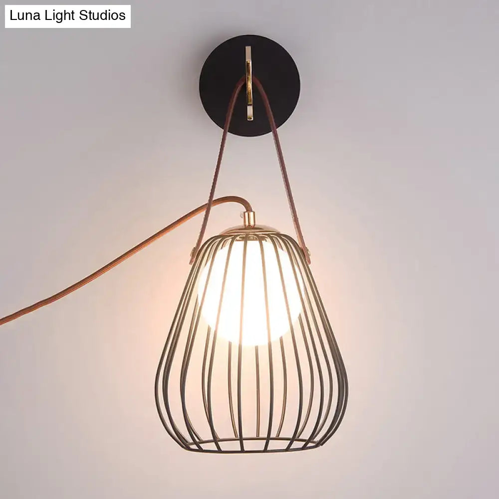 Minimalist black finish pear cage iron wall sconce with brass frame and brown leather straps for bedroom lighting