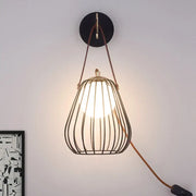 Minimalist black finish pear cage iron wall sconce with warm pendant light and brown leather straps for bedroom use