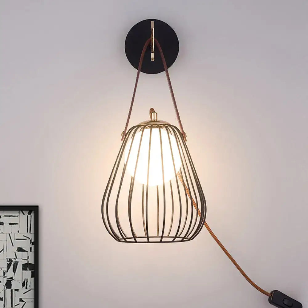 Minimalist black finish pear cage iron wall sconce with warm pendant light and brown leather straps for bedroom use