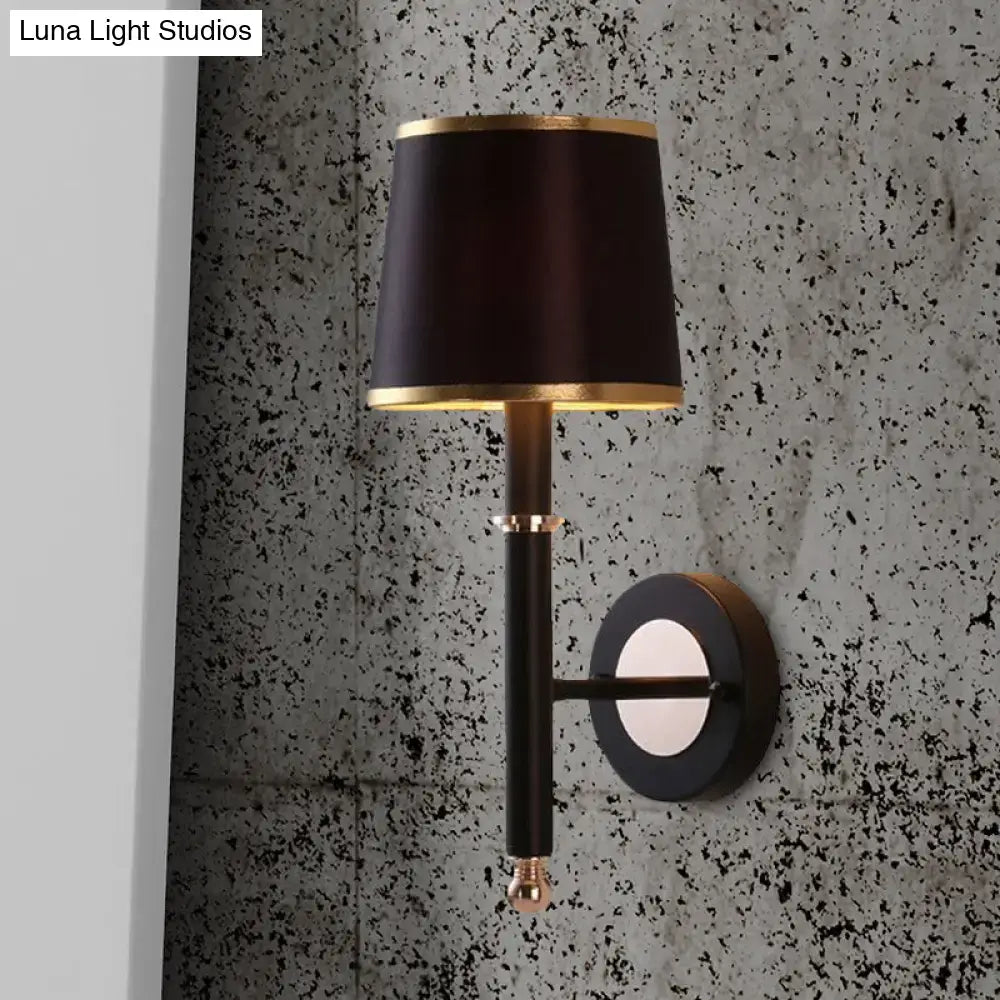 Minimalist black flaxen sconce light with black satin lampshade and gold trim on metal arm for 110v-120v 220v-240v use