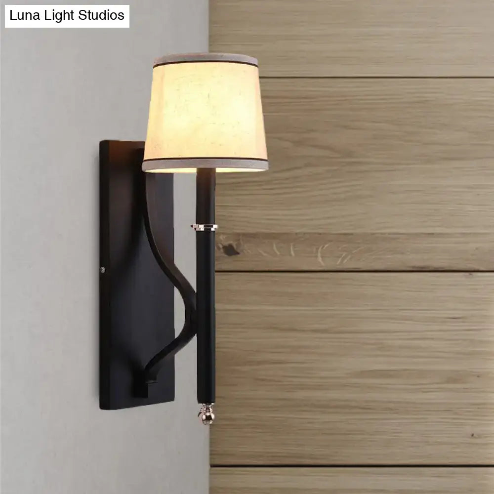 Minimalist black flaxen sconce light featuring black wrought iron with cream fabric shade and silver accents for 110v-120v 220v-240v use
