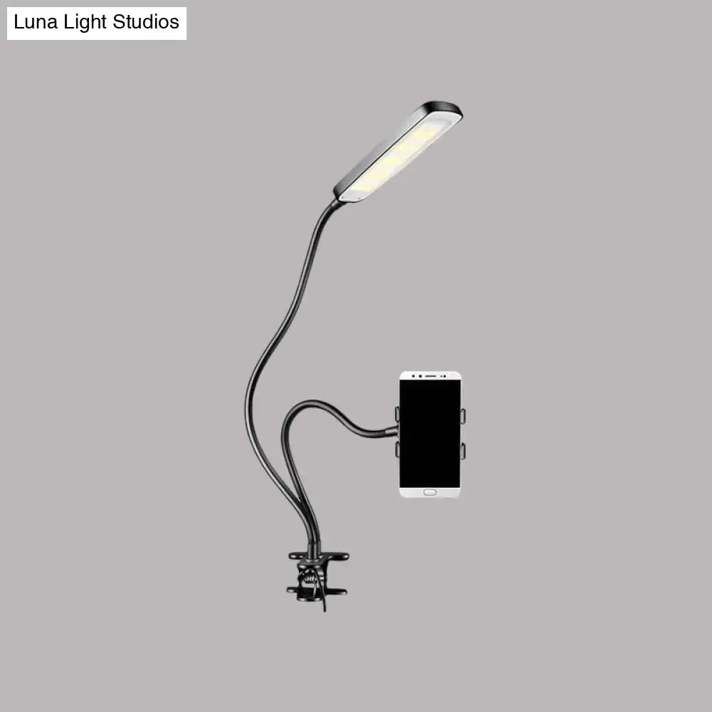Minimalist black flexible arm desk lamp with led light head and phone clamp base for bedroom use