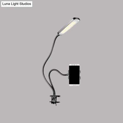 Minimalist black flexible arm desk lamp with led light head and phone clamp base for bedroom use