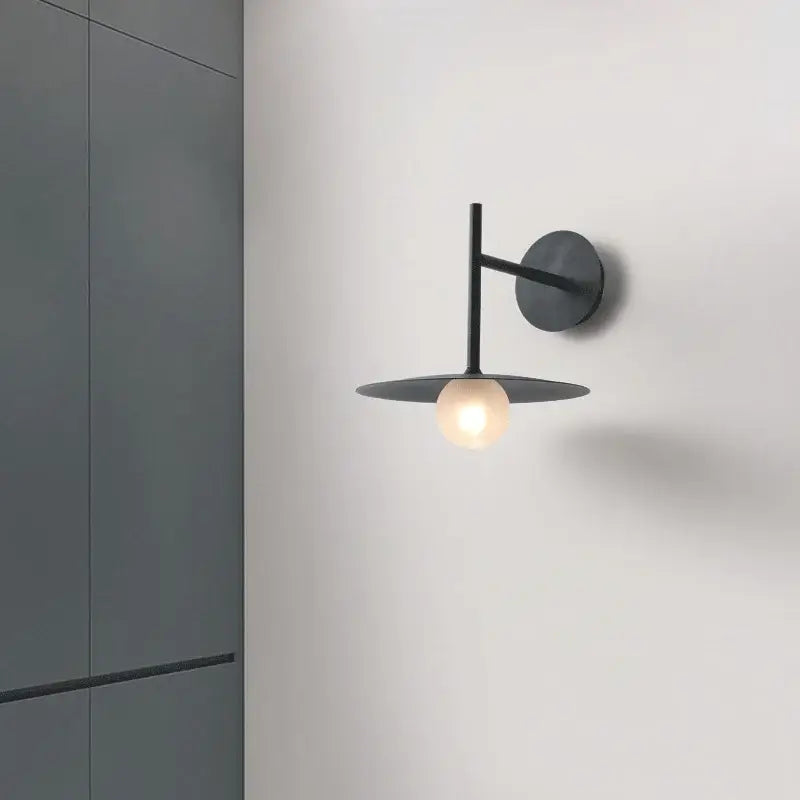Minimalist black metal flying saucer wall lamp with circular base and disc shade for bedroom decorbites flying saucer decor