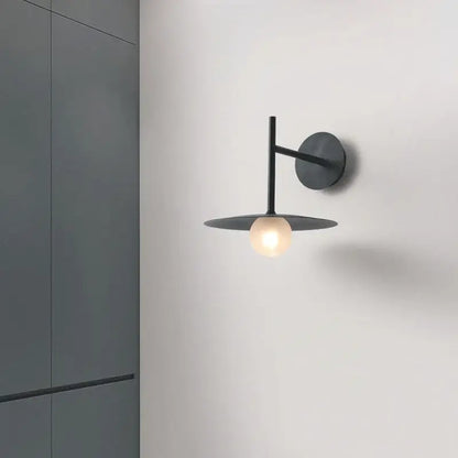 Minimalist black metal flying saucer wall lamp with circular base and disc shade for bedroom decorbites flying saucer decor