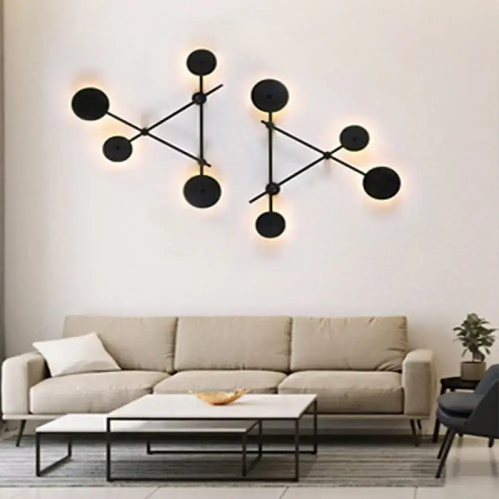 Minimalist black geometric wall light fixture with circular molecular-style design for living room wall lighting