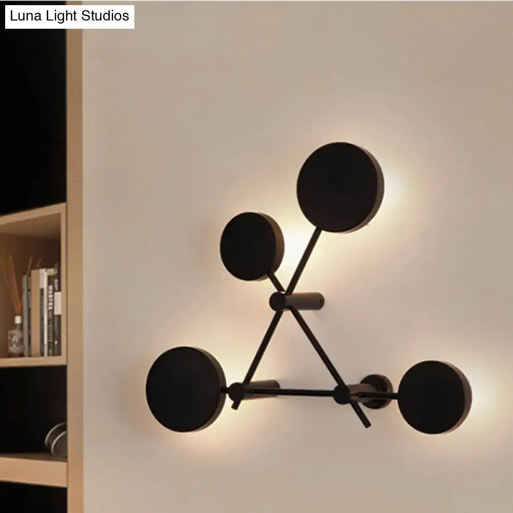 Minimalist black geometric wall light fixture with circular light fixtures in a molecular-inspired design for living room