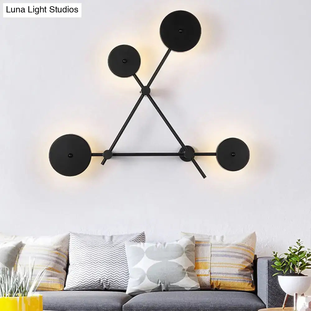 Minimalist black geometric wall light fixture with circular light fixtures and angular metal arms for living room