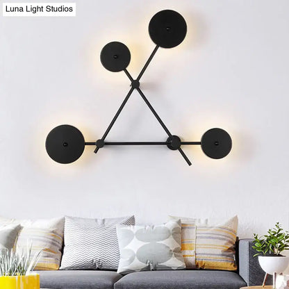 Minimalist black geometric wall light fixture with circular light fixtures and angular metal arms for living room