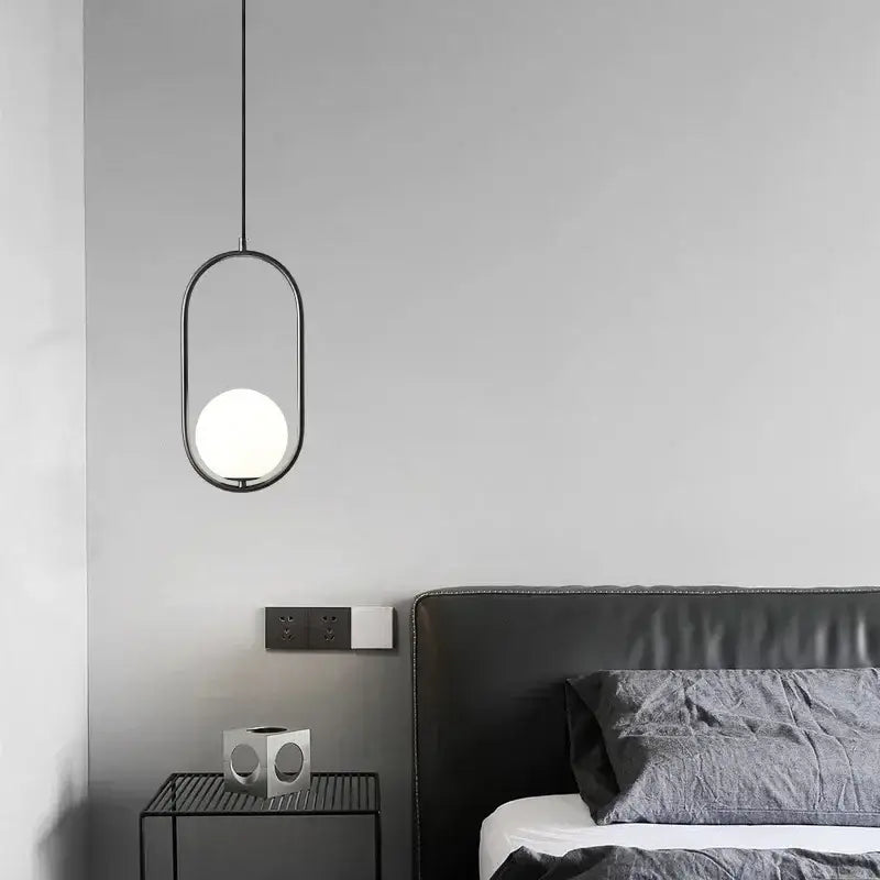 Minimalist black metal pendant lamp with a frosted white glass ball bulb for dining room decorbites glass ball