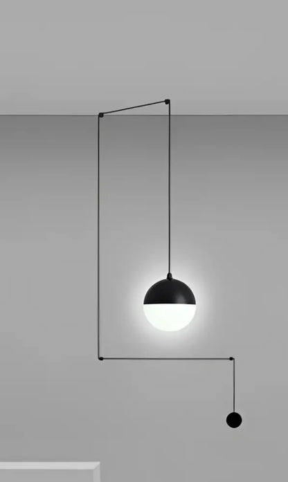 Minimalist black glass ball pendant light with glowing white bulb and geometric metal frame for kitchen decorbites glass ball