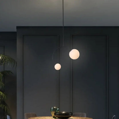 Minimalist black glass ball pendant lights with two frosted glass spheres suspended by thin black cord for dining room decorbites glass ball pendant