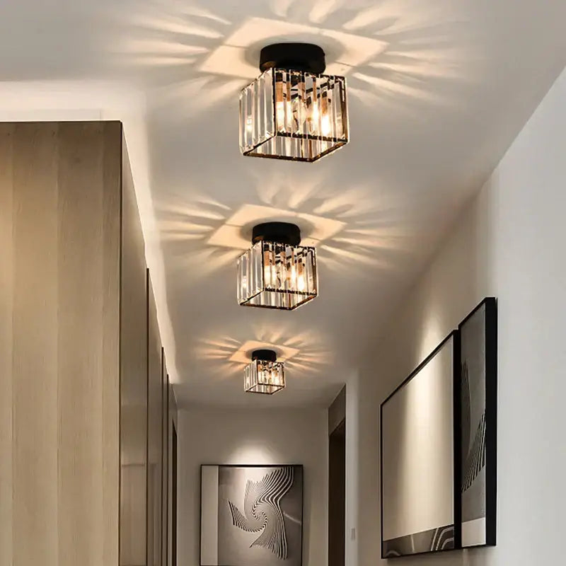 Minimalist black and gold decorbites crystal ceiling chandelier with vertical glass rods and warm radiant illumination