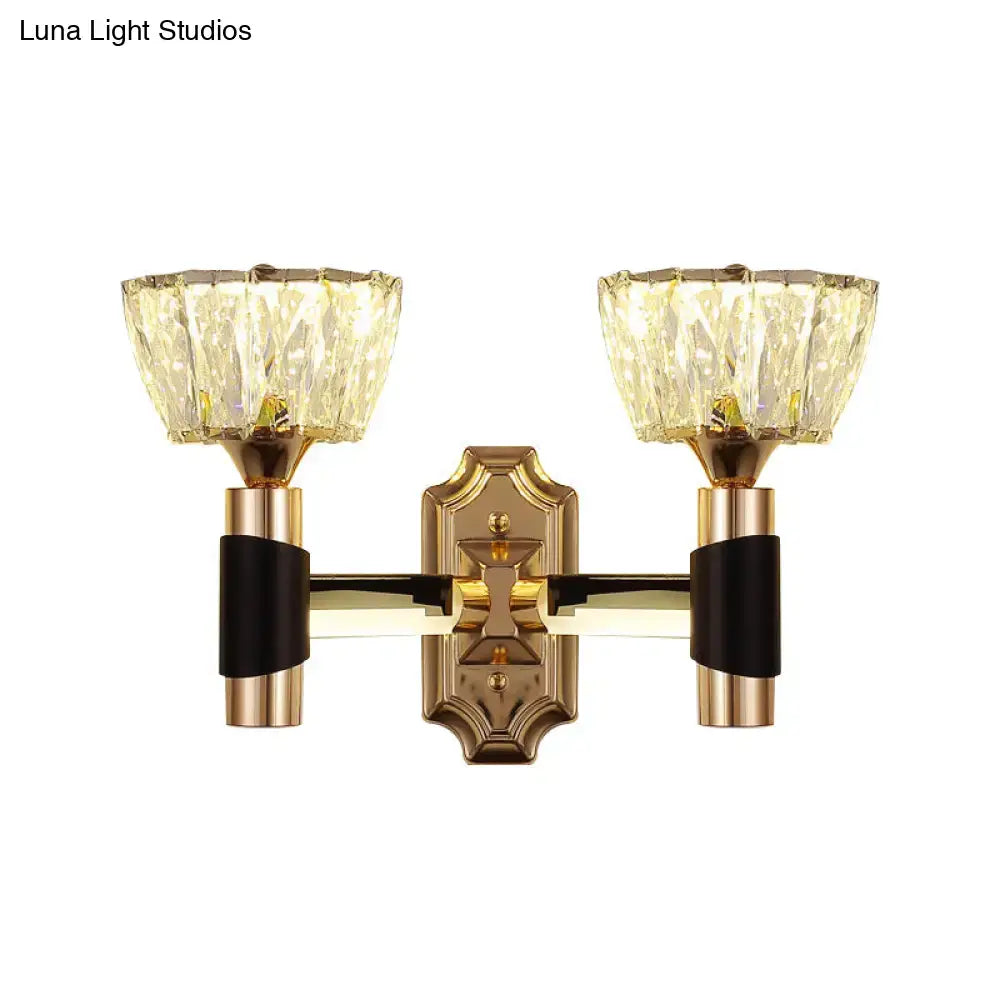Gold-toned minimalist wall sconce with black accents and two faceted crystal shades compatible with e26 e27 bulb base