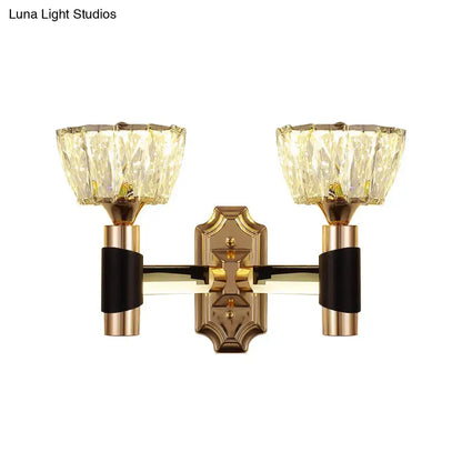 Gold-toned minimalist wall sconce with black accents and two faceted crystal shades compatible with e26 e27 bulb base