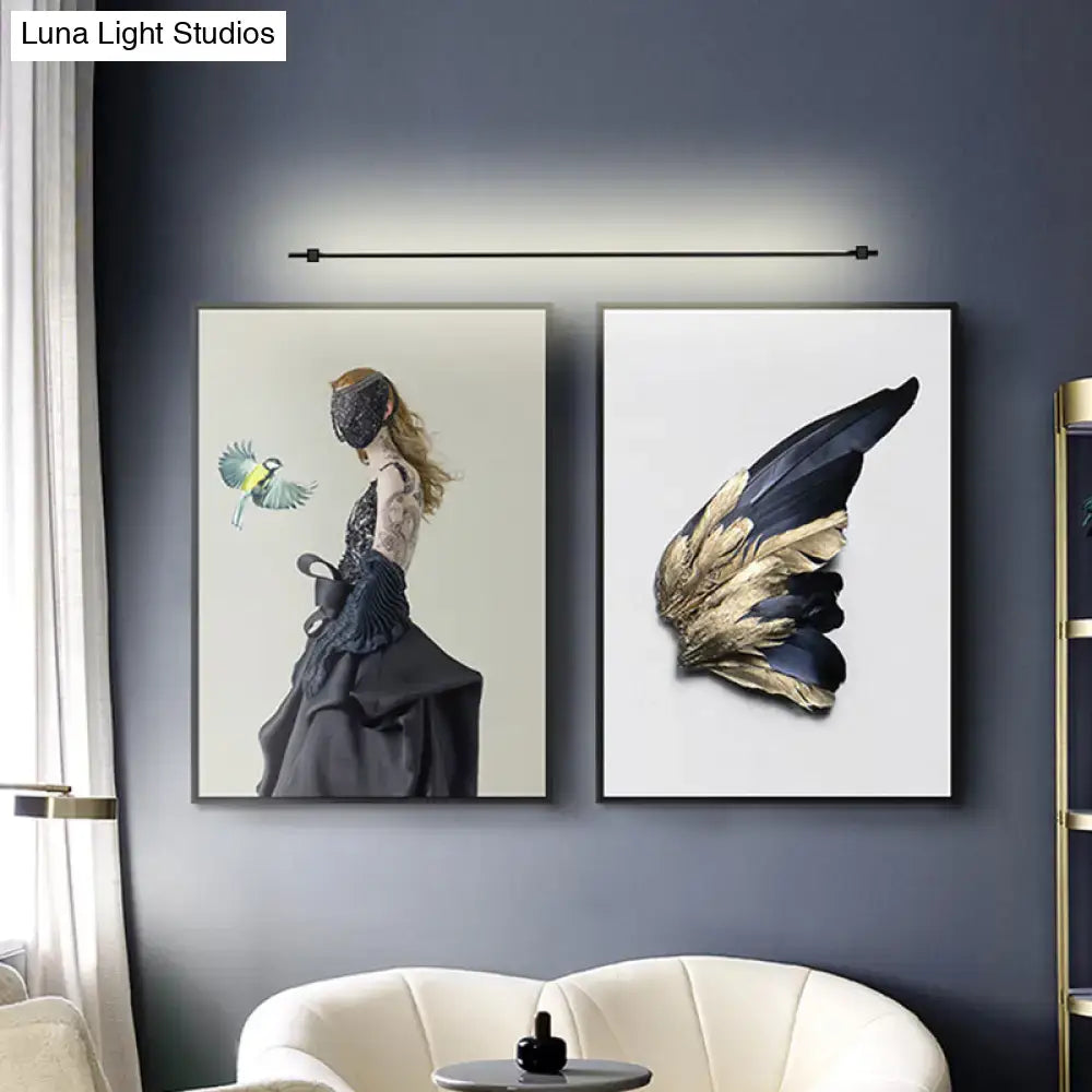 Minimalist black and gold feather wing wall light fixture designed for elegant living room decor and lighting