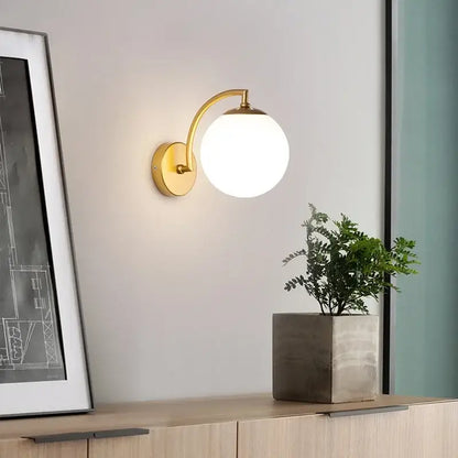 Gold-finished minimalist black and gold glass ball wall light with spherical frosted glass shade decorbites glass ball wall light