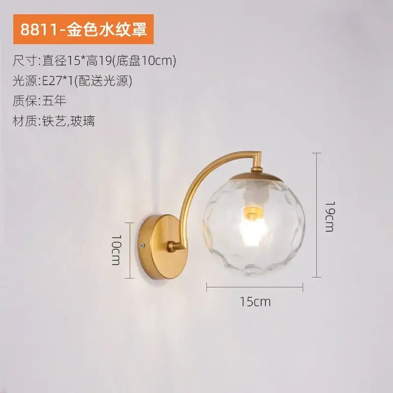 Minimalist gold finished glass ball wall sconce with faceted globe featured in decorbites glass ball collection