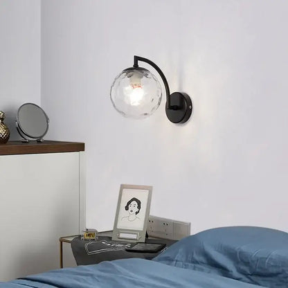 Minimalist black metal wall sconce with textured clear glass globe for decorbites glass ball wall light bedroom decor