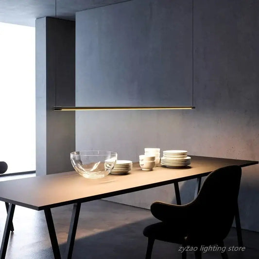 Minimalist black and gold led pendant light with sleek linear design and black finish hanging above dining table