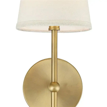 Brass-finished minimalist led wall lamp with cylindrical stem and off-white fabric shade for bedroom lighting