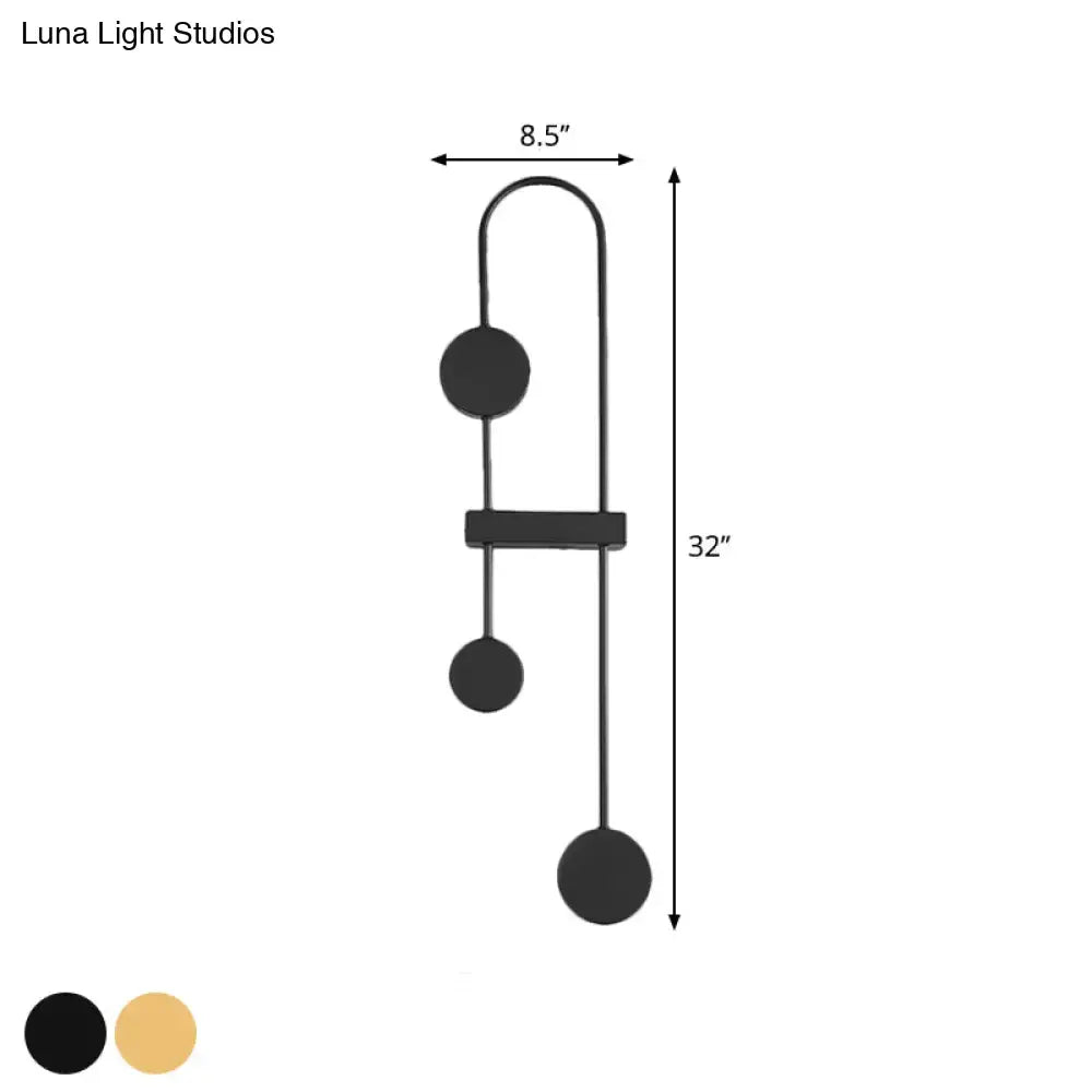 Minimalist black and gold metal led wall sconce with three spherical bulbs and a central rectangular bar for bedroom lighting