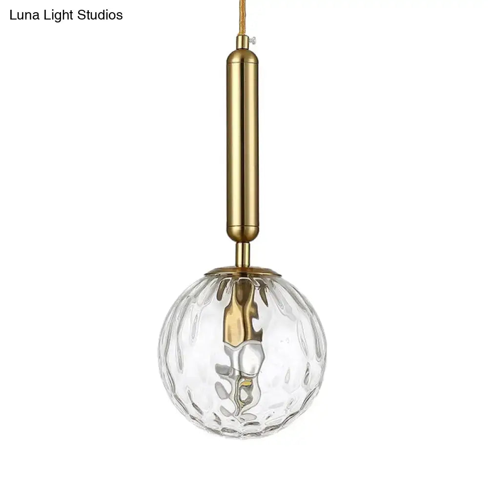 Minimalist black gold spherical wall sconce with clear textured glass globe and brass inch fixture for bedroom lighting