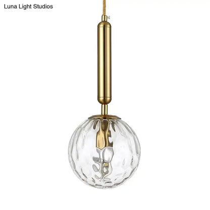 Minimalist black gold spherical wall sconce with clear textured glass globe and brass inch fixture for bedroom lighting