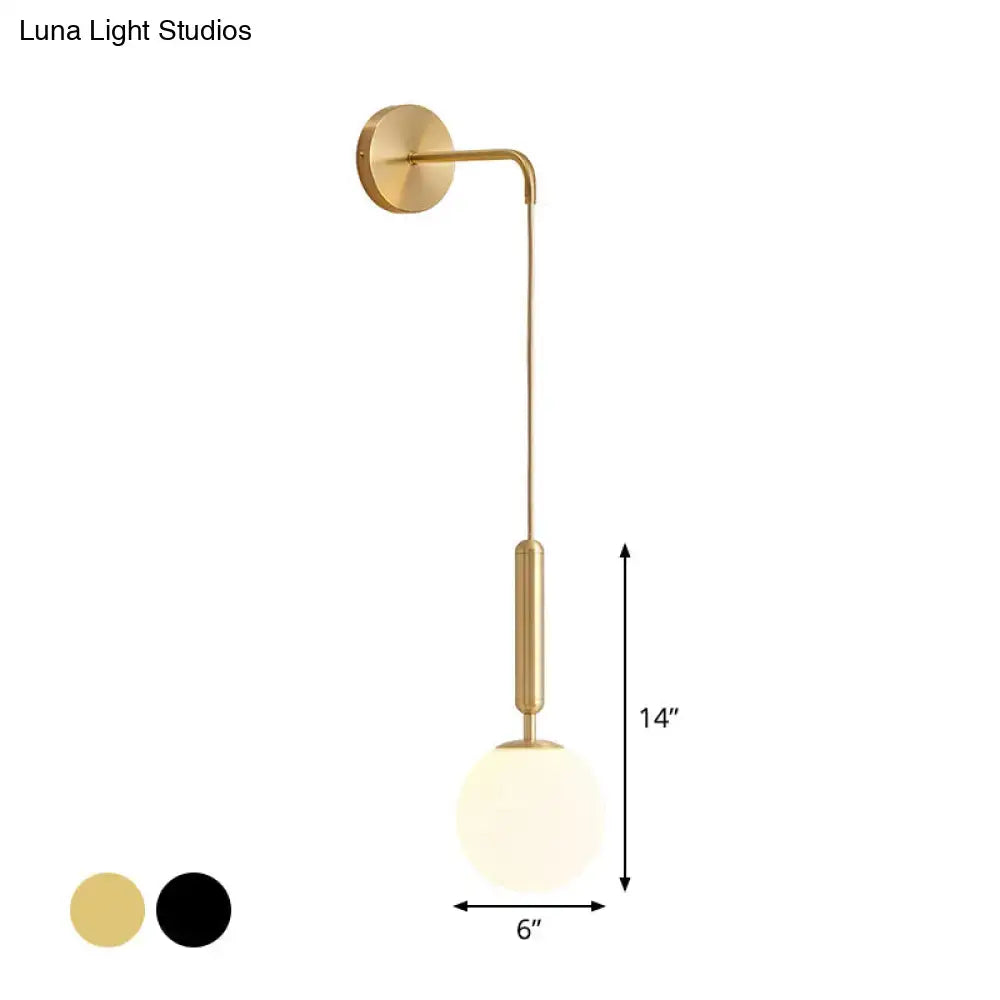 Minimalist black gold wall sconce with a gold-finished curved arm and frosted glass globe 12 inch fixture for bedrooms