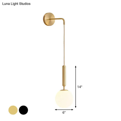 Minimalist black gold wall sconce with a gold-finished curved arm and frosted glass globe 12 inch fixture for bedrooms