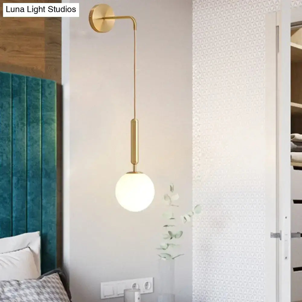 Gold-finished black gold 8 inch fixture wall-mounted sconce with slender curved arm and spherical frosted glass globe