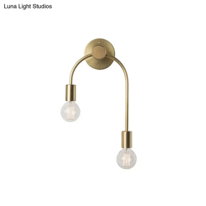 Brass-finished minimalist black and gold double arm wall lamp with two exposed filament bulbs for bedroom use