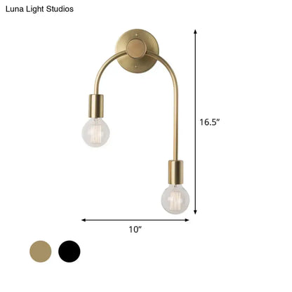 Brass-finished double-arm wall lamp with two exposed bulbs in black and gold for minimalist bedroom lighting