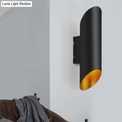 Minimalist black and gold wall light with cylindrical design and gold interior lining for corridor and bedroom use