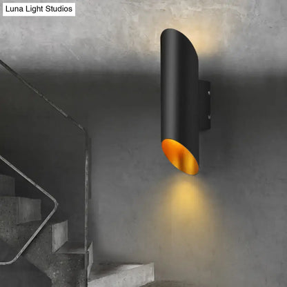 Minimalist black wall light with gold interior lining and cylindrical design for corridor and bedroom lighting