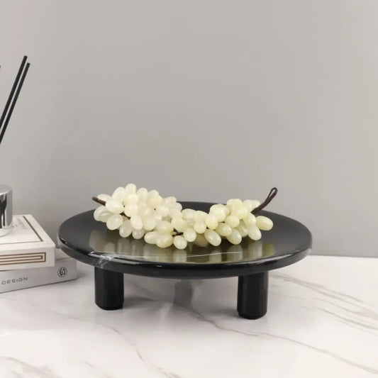 Minimalist black imitation marble fruit tray with two legs holding white faux grapes for dining room decorbites imitation marble