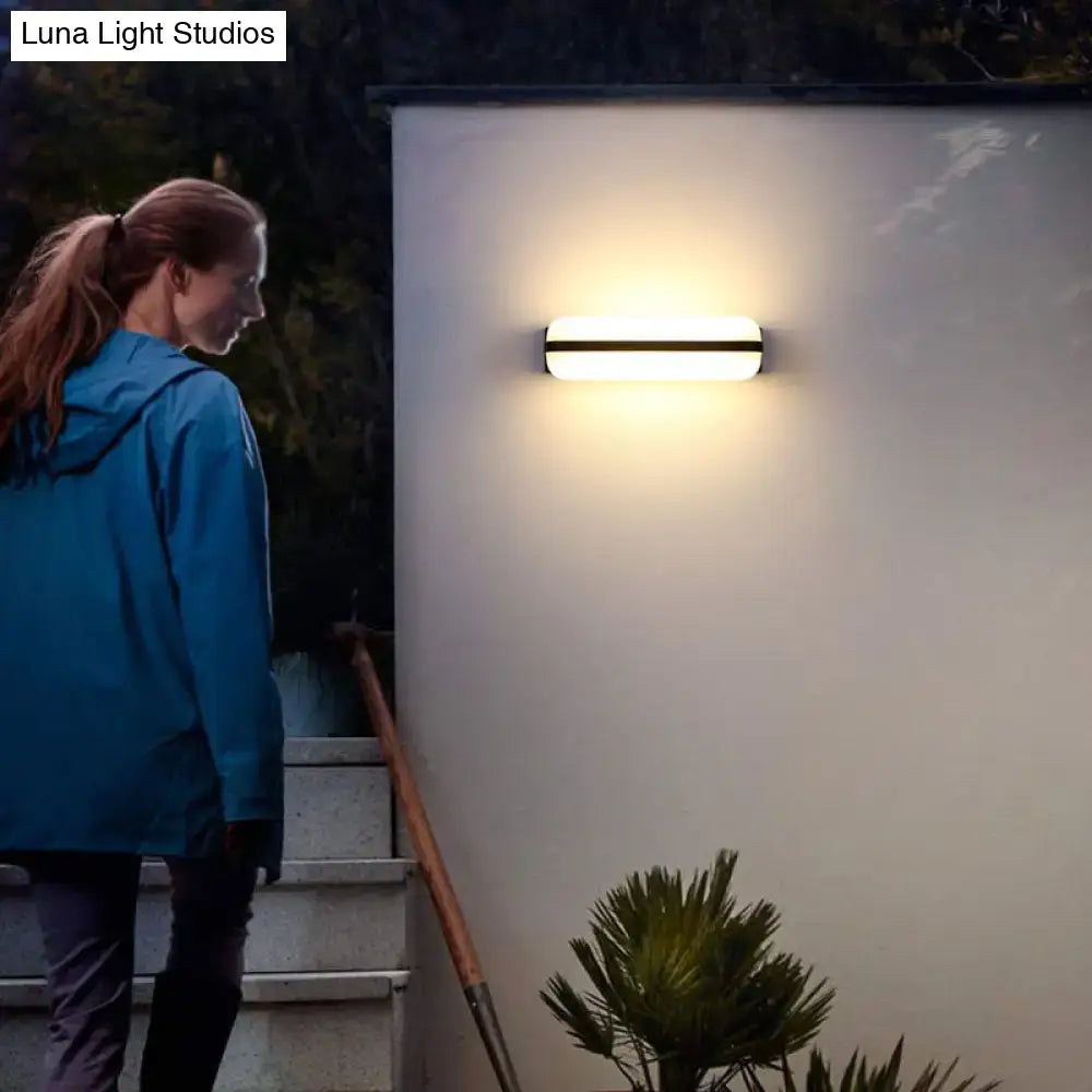 Minimalist black led wall sconce with white diffuser and black frame emitting warm light for 220v-240v use