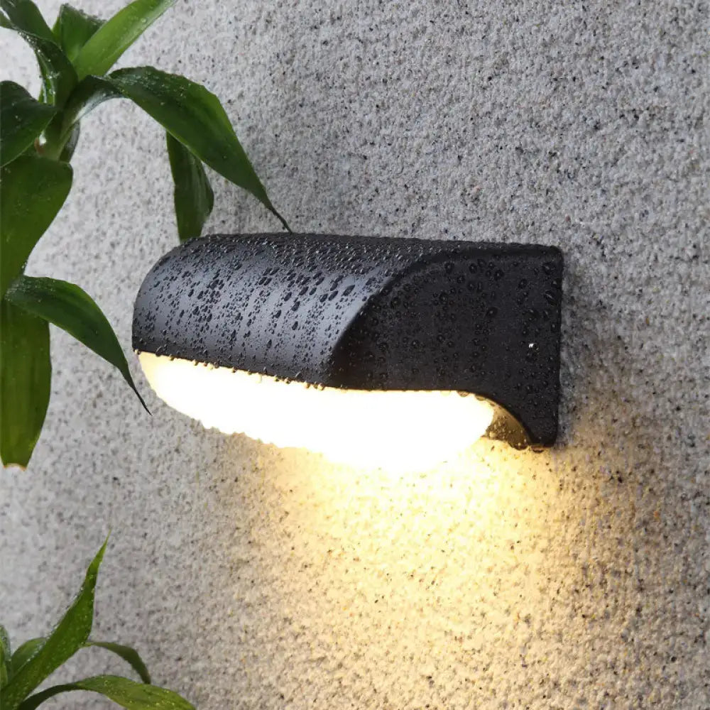 Minimalist black outdoor wall sconce with curved matte finish emitting warm light for 220v-240v or 110v-120v use