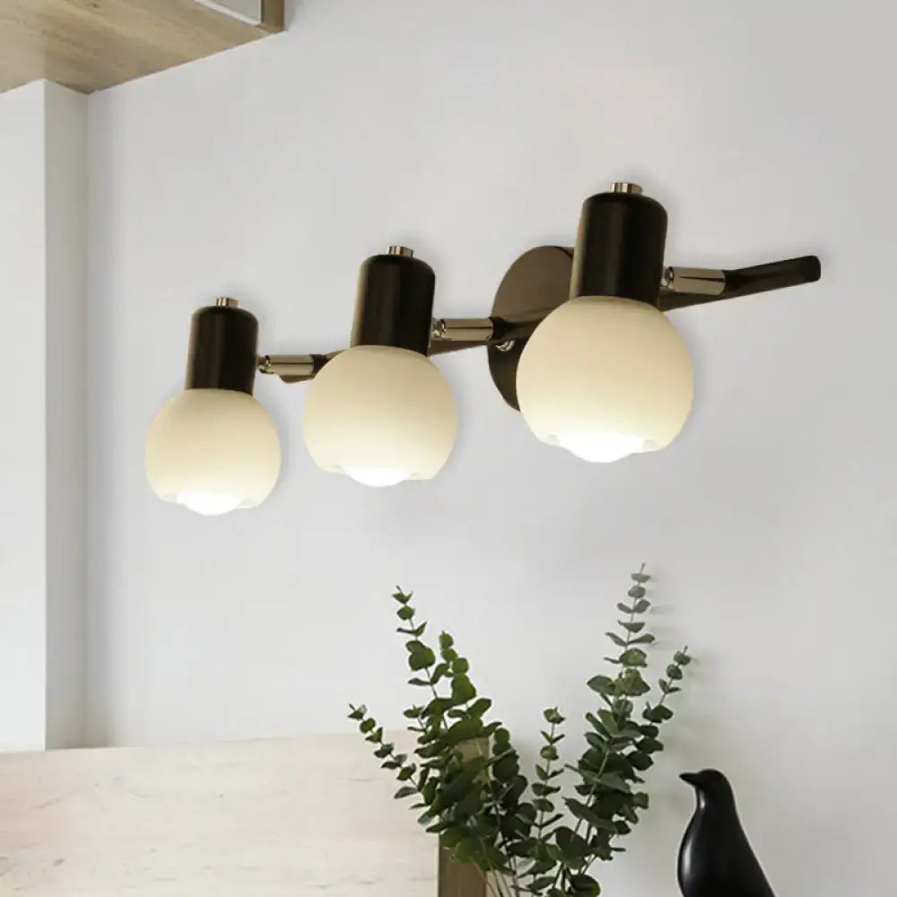 Minimalist black wall lamp with linear design and opal glass frosted globes for a study room lighting solution