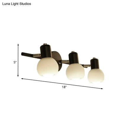 Modern three-light wall lamp with linear design black cylindrical fixtures and opal glass shades for study room use