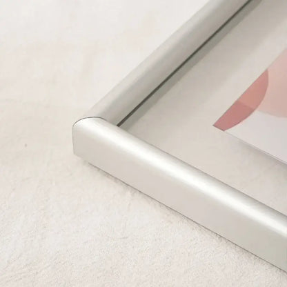 Silver aluminum corner of minimalist black mademoiselle hangable picture frame with rounded edges for bedroom art