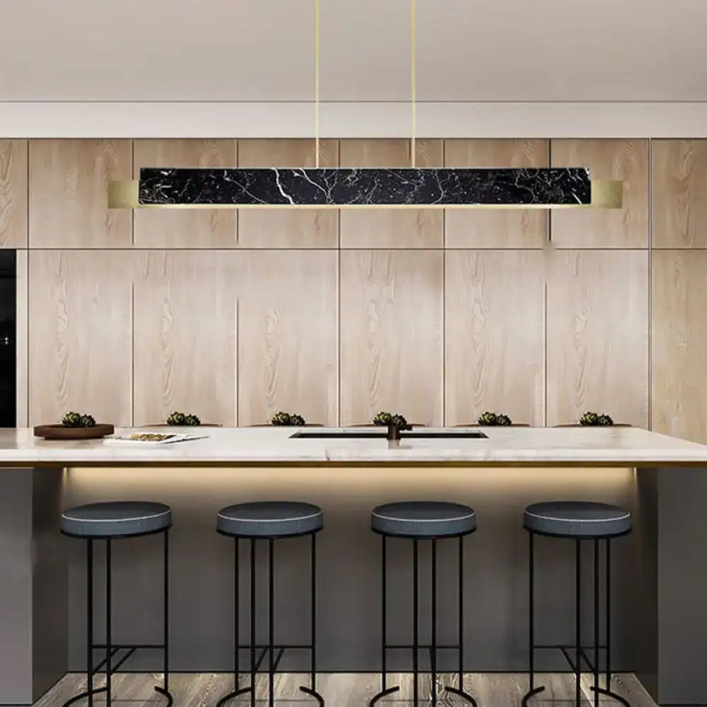 Minimalist black marble rectangular pendant light with gold accents and black cord for dining room lighting