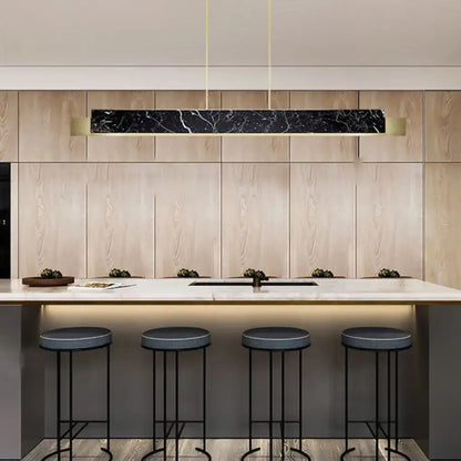 Minimalist black marble rectangular pendant light with gold accents and black cord for dining room lighting
