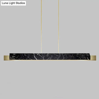 Minimalist black marble rectangular dining room light with gold accents and black cord hanging cords