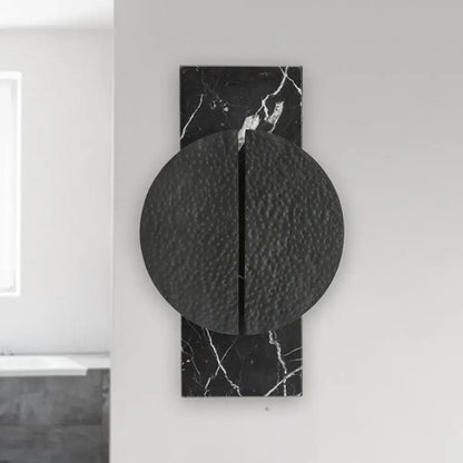 Minimalist black marble wall lamp with textured circular disc and vertical seam for living space 110v-120v 220v-240v use