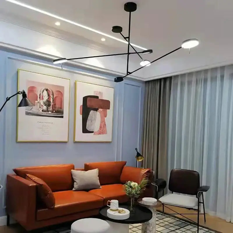 Orange leather sofa with light gray throw pillows below minimalist black metal led pendant light for living room decorbites black metal