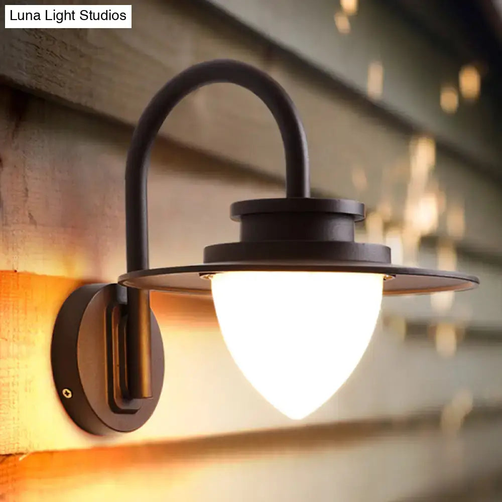 Minimalist black wrought iron outdoor wall sconce with frosted glass shade and 60w maximum bulb wattage