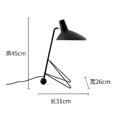 Minimalist black metal tripod desk lamp with sleek design and sturdy tripod base for bedroom or office use